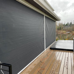 Patio with rolled window shades on a rainy day.