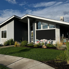 Modern house with lawn under blue sky
