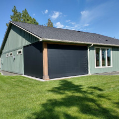 Green house with large garden, blue sky