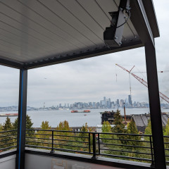 Seattle skyline view from rooftop with crane.