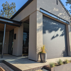 Modern house with large sun shade on patio