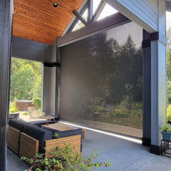 Modern patio with outdoor seating and large sunshade.
