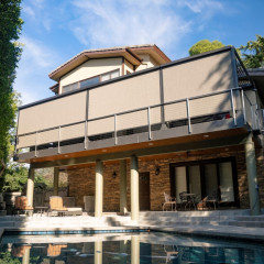 Modern house with pool and patio furniture.