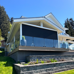Modern house with glass balcony and black screen